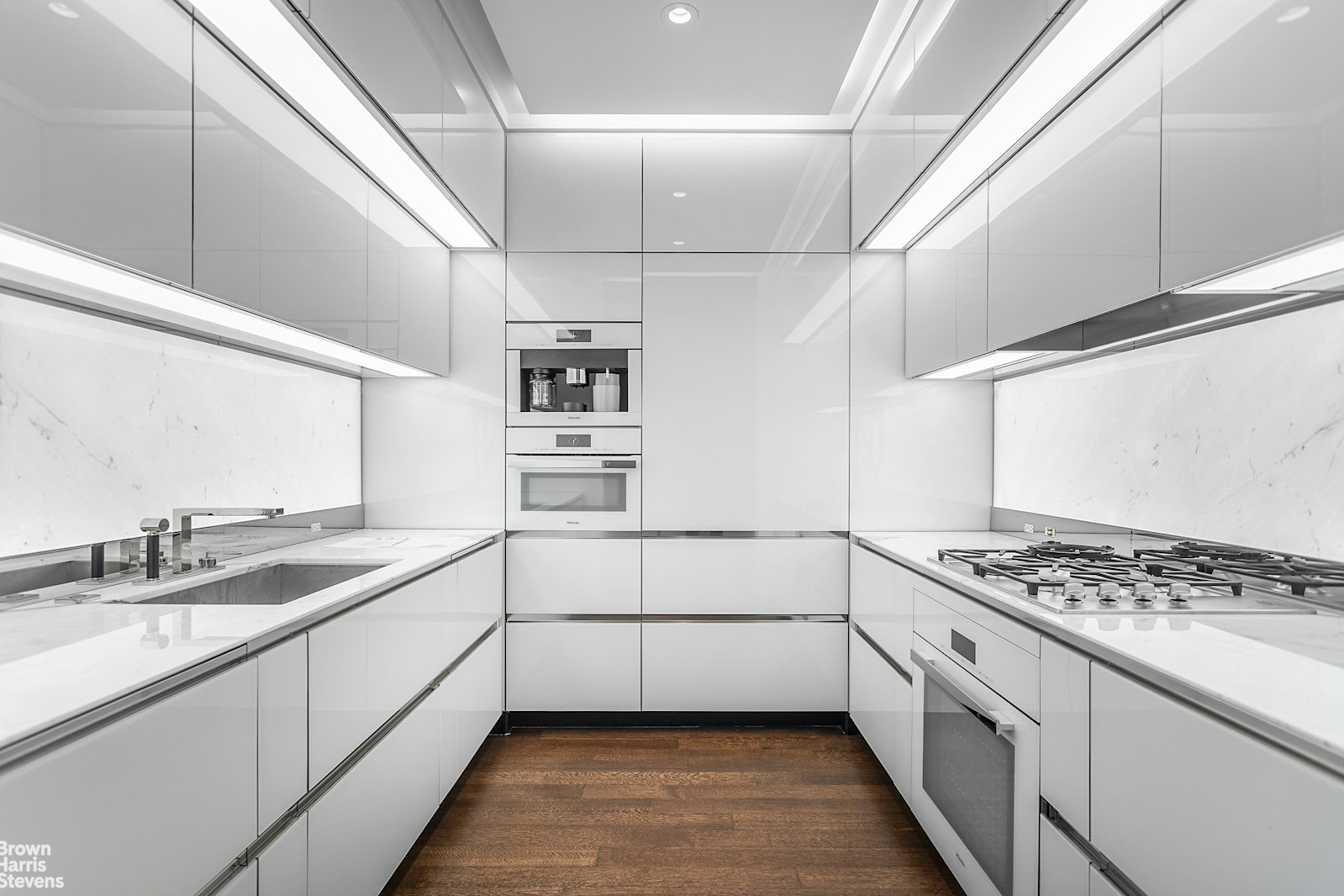53 West 53rd Street, Unit 24F Manhattan, NY 10019 - Photo 5 of 10 a kitchen with granite countertop a sink and cabinets