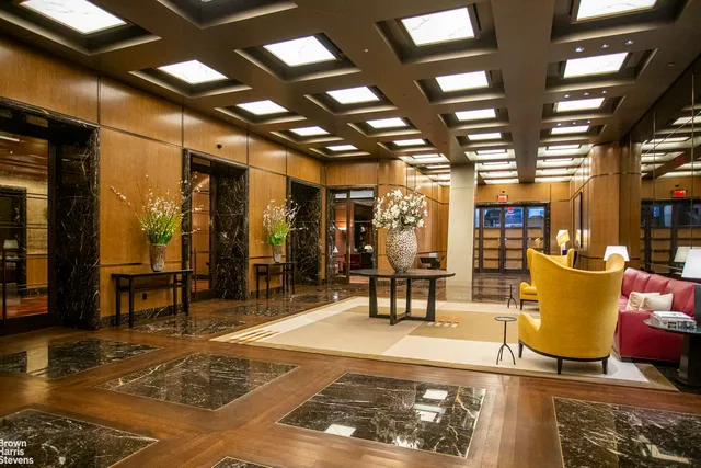 a bathroom with a double vanity sink mirror and bathtub