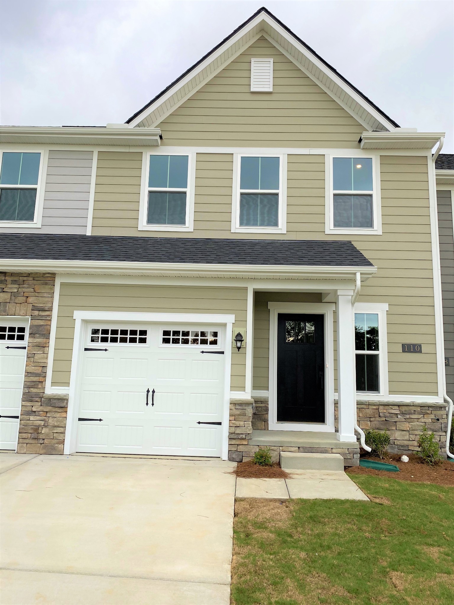 110 Keelon Gap Road, Unit 104C Spring Hill, TN 37174 - Photo 2 of 22 a front view of a house with a yard and garage