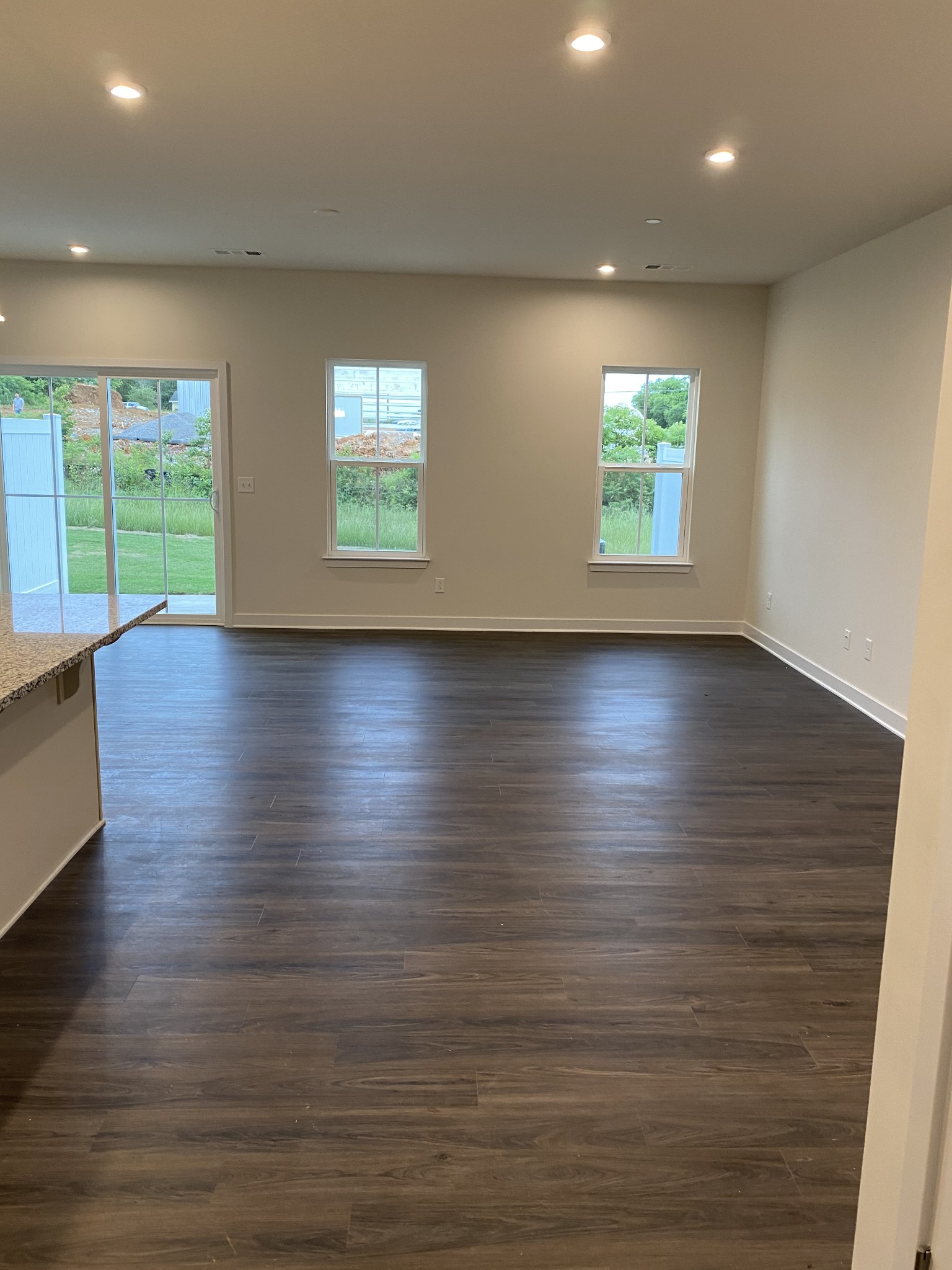 110 Keelon Gap Road, Unit 104C Spring Hill, TN 37174 - Photo 4 of 22 an empty room with wooden floor and windows