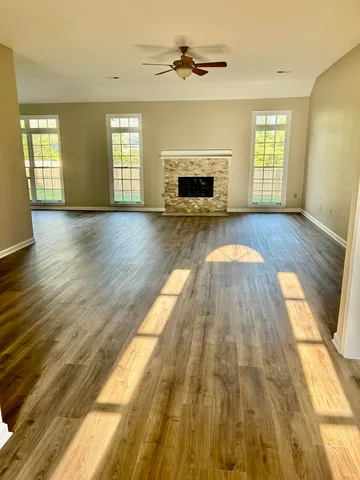 a room with kitchen island a sink a stove and a large window