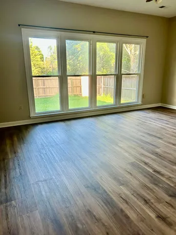 a spacious bathroom with a granite countertop sink and a mirror