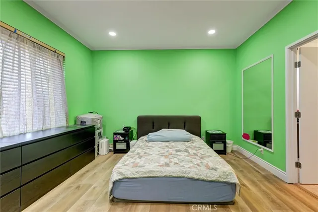 a large bedroom with a bed and a window