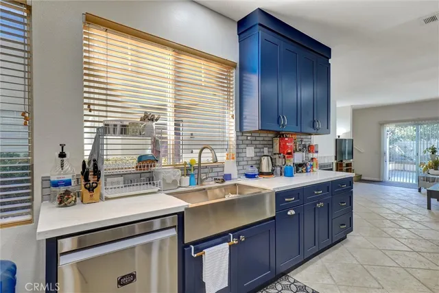 a room with a sink cabinets and window