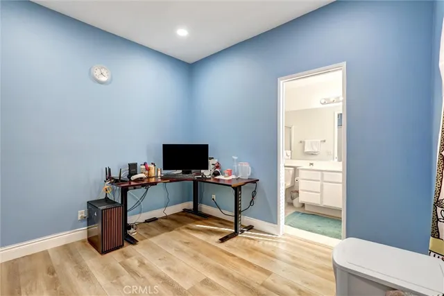 a view of a workspace with furniture and a window