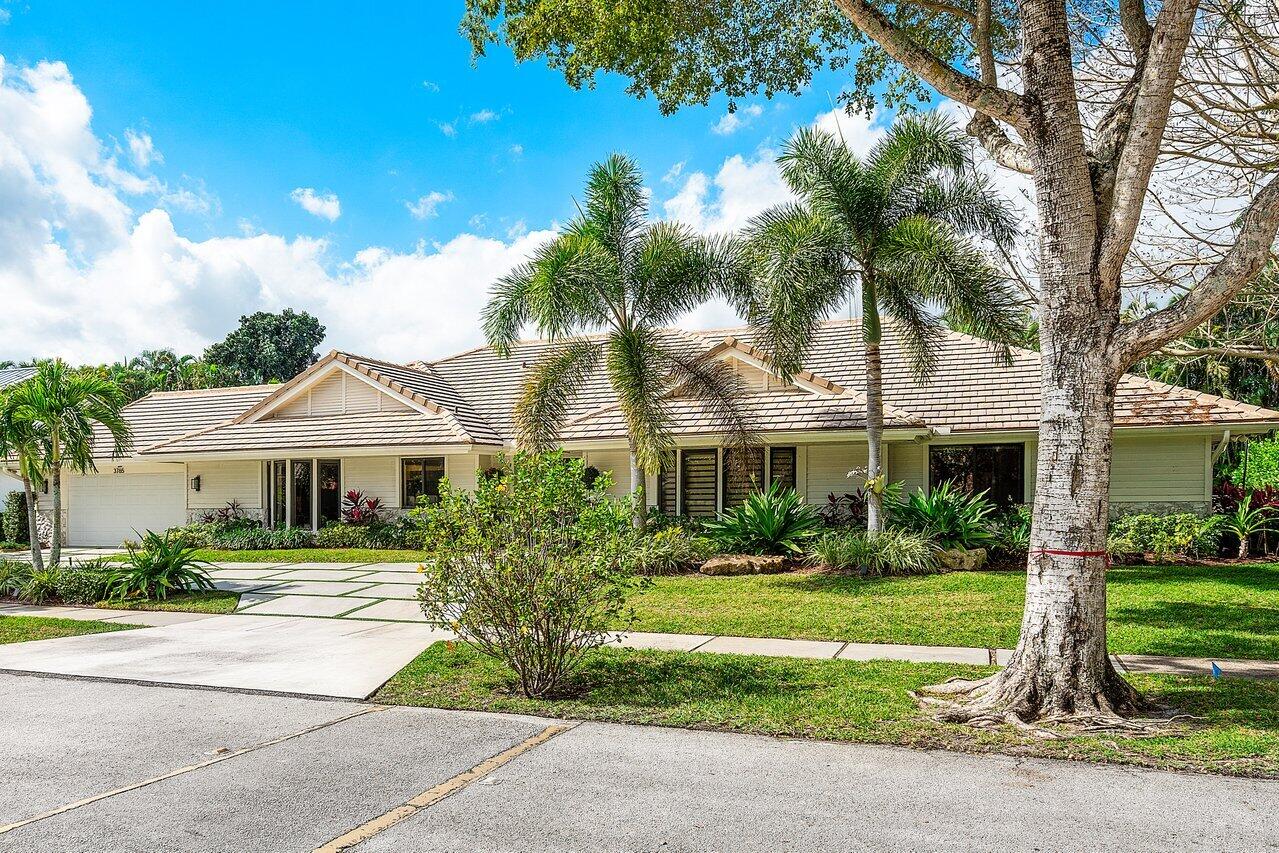3765 Kings Way Boca Raton, FL 33434 - Photo 2 of 60 a front view of a house with a yard