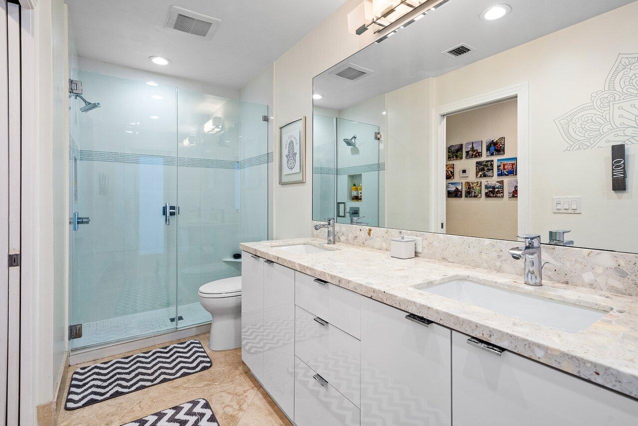 3765 Kings Way Boca Raton, FL 33434 - Photo 29 of 60 a bathroom with a granite countertop sink a toilet a shower and a mirror
