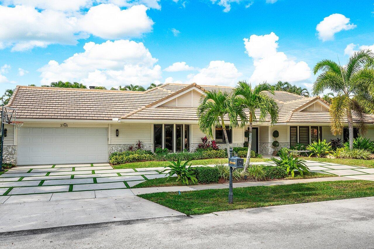 3765 Kings Way Boca Raton, FL 33434 - Photo 3 of 60 a front view of a house with garden