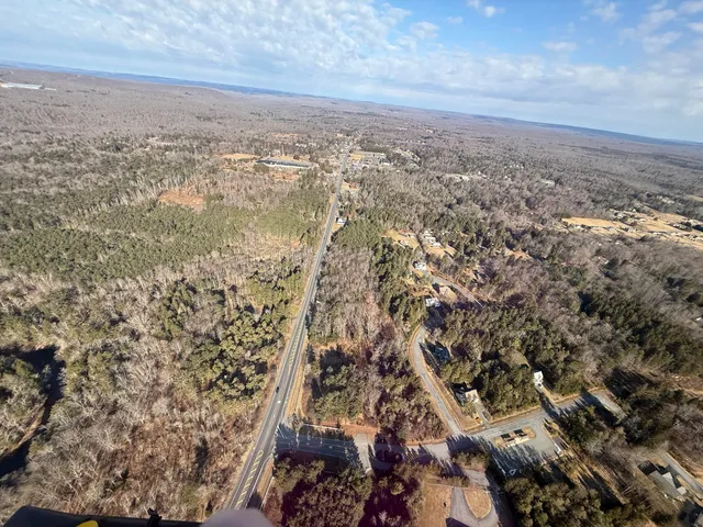 a view of wooden floor with a house in the background