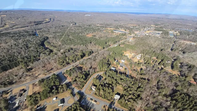an aerial view of house with yard and mountain view in back