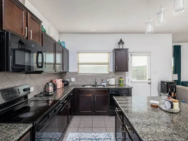 a kitchen with a sink stove and cabinets