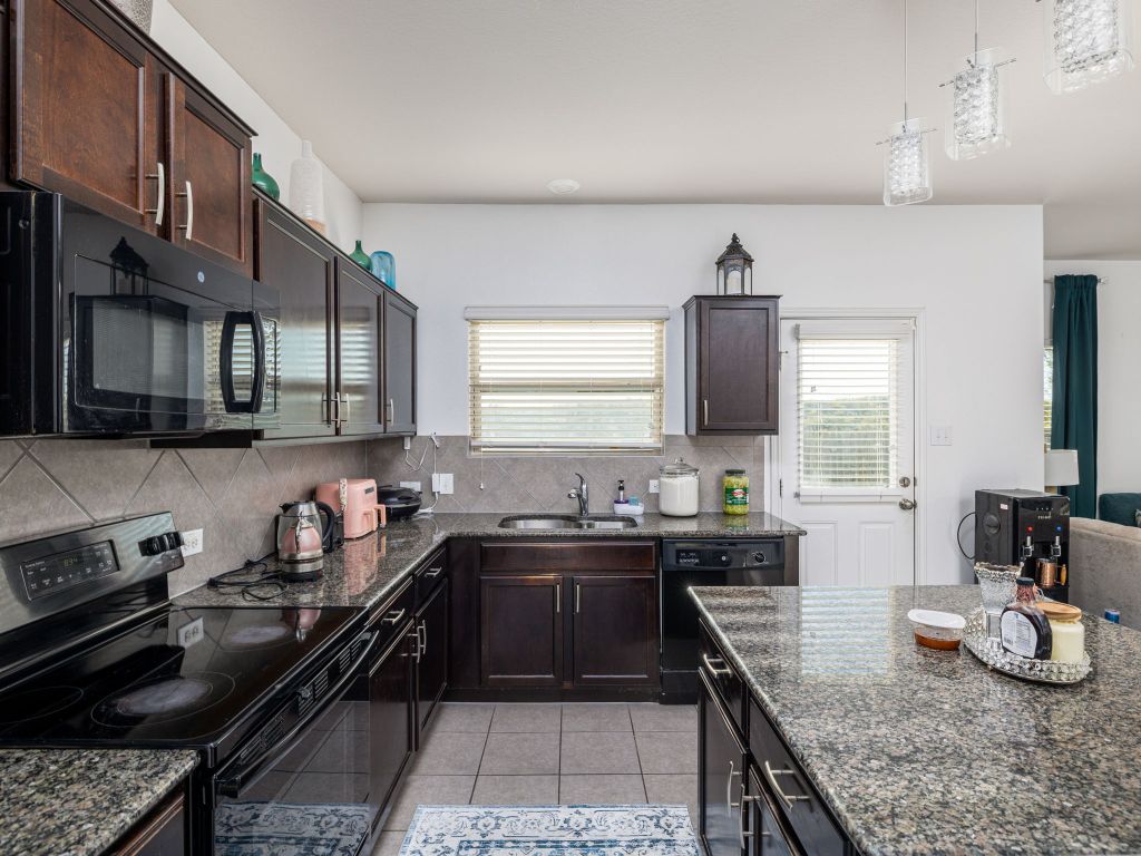 464 Druse Lane Jarrell, TX 76537 - Photo 12 of 26 a kitchen with a sink stove and cabinets