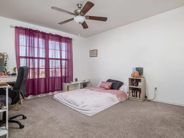 a bedroom with a bed and a desk