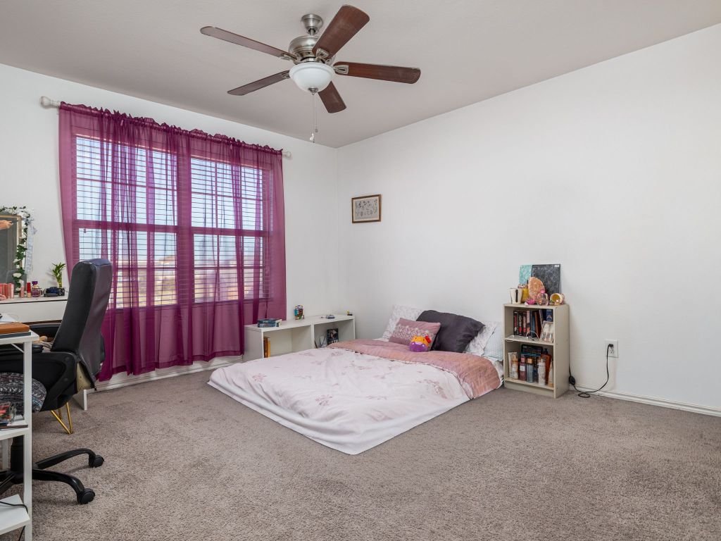 464 Druse Lane Jarrell, TX 76537 - Photo 17 of 26 a bedroom with a bed and a desk