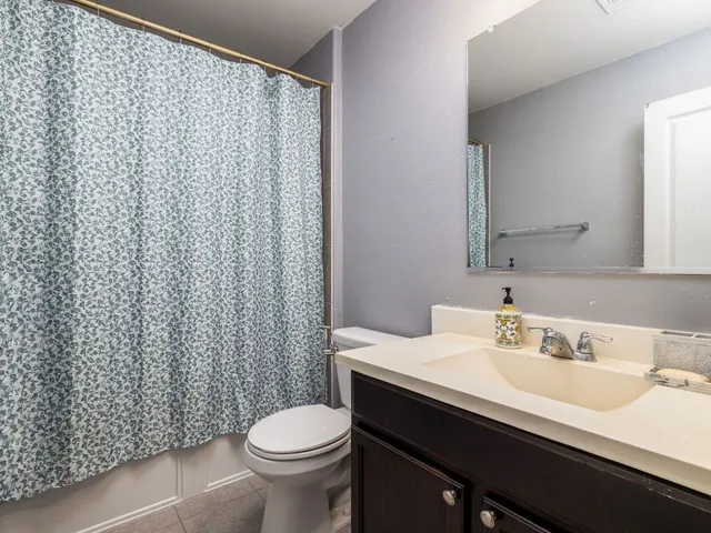 a bathroom with a sink toilet and a mirror