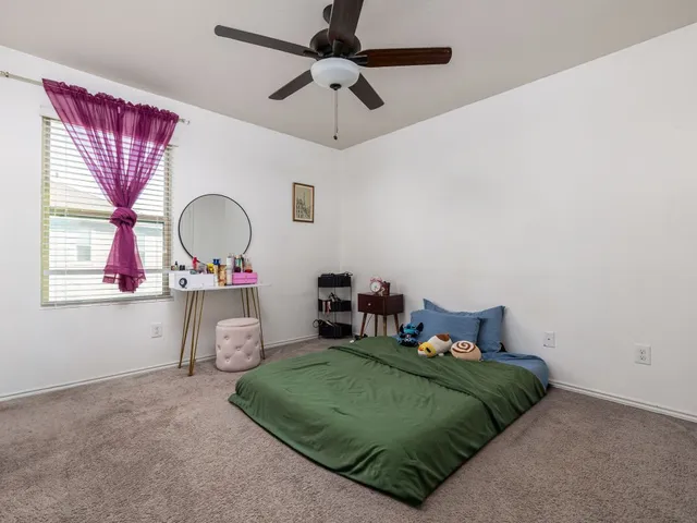 a bedroom with a bed dresser and a window