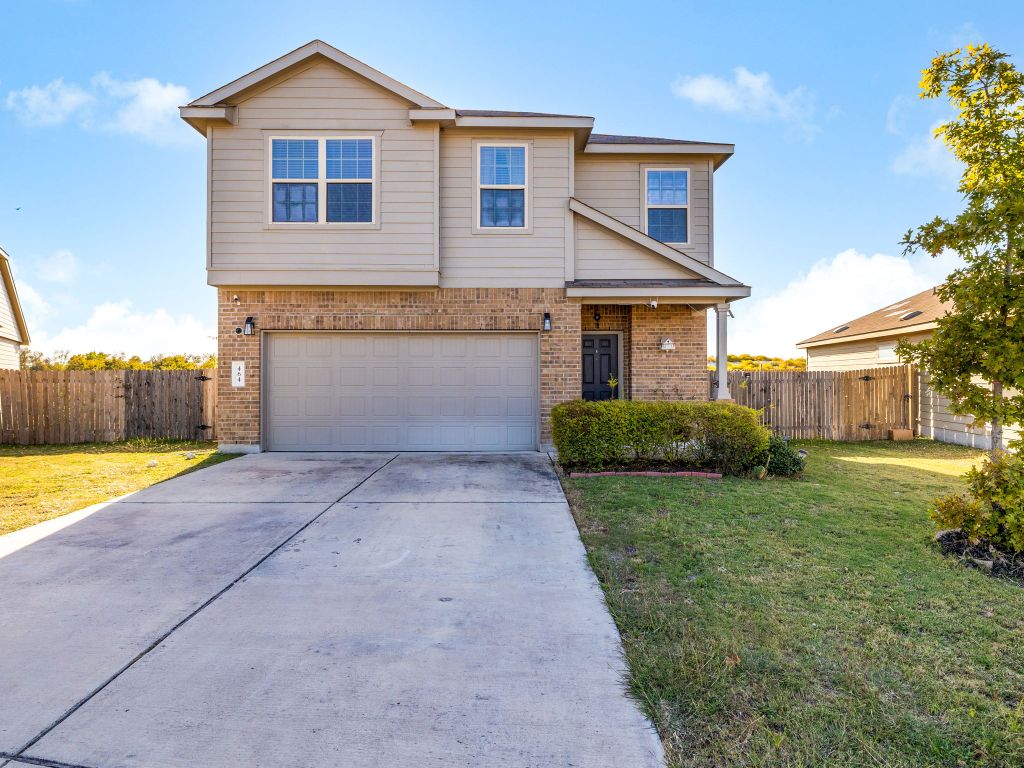464 Druse Lane Jarrell, TX 76537 - Photo 2 of 26 a front view of a house with a yard and garage