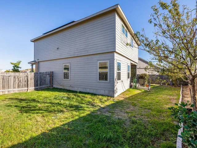 a backyard of a house with table and chairs