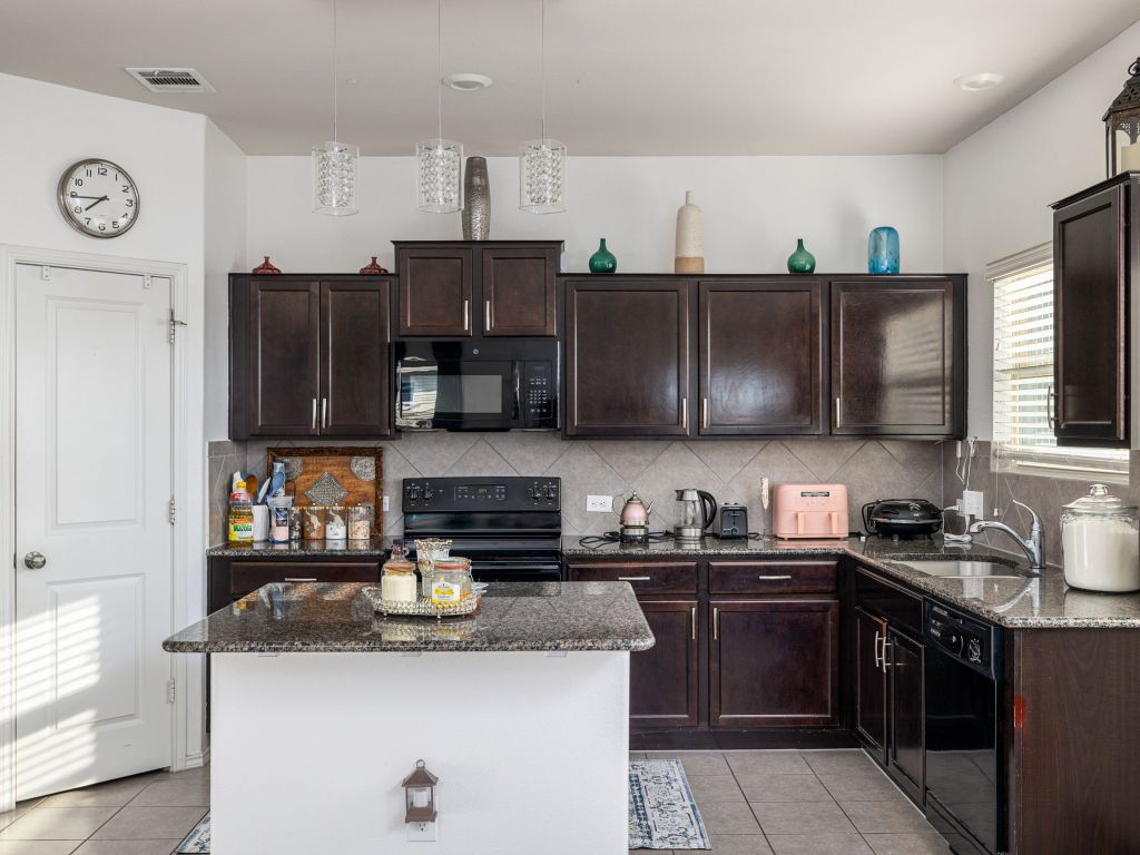464 Druse Lane Jarrell, TX 76537 - Photo 10 of 26 a kitchen with stainless steel appliances granite countertop a sink stove and refrigerator