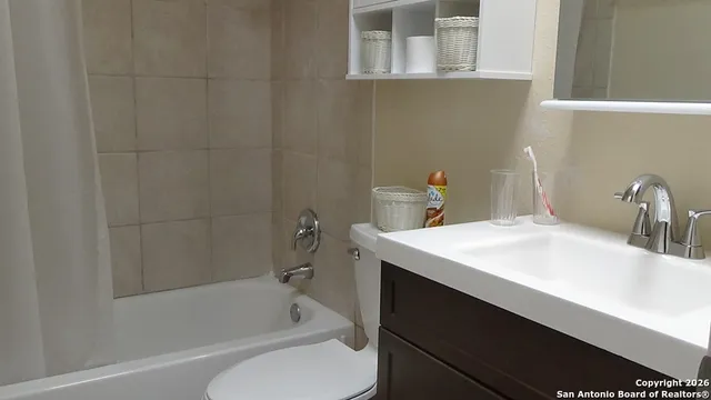 a bathroom with a sink a toilet and bathtub