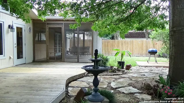a view of a backyard with chair and table
