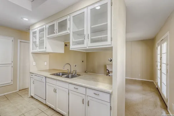 a kitchen with stainless steel appliances granite countertop a sink and cabinets