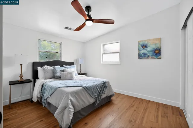 a bedroom with bed and wooden floor