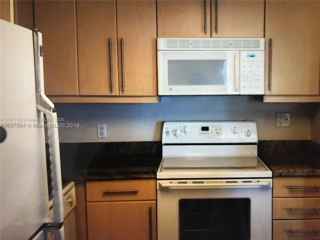 a stove top oven sitting inside of a kitchen