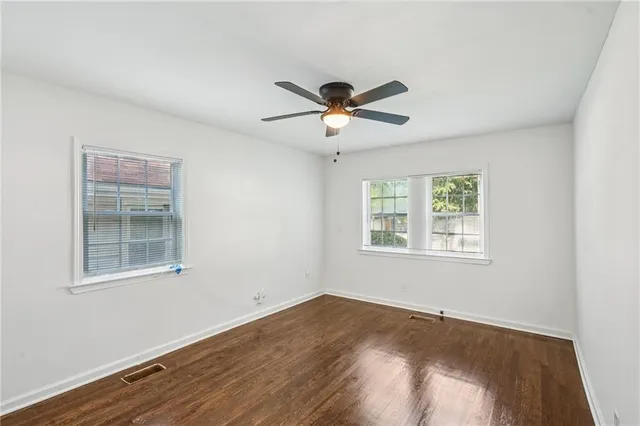 a view of a room with wooden floor and windows