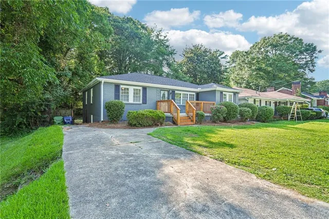 a view of a house with yard and a garden