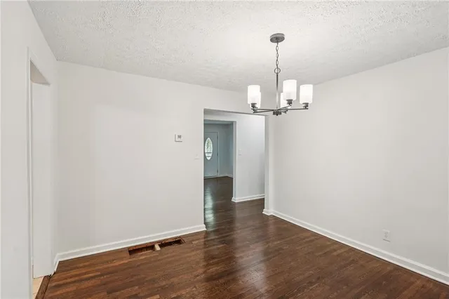 a view of a room with wooden floor and window