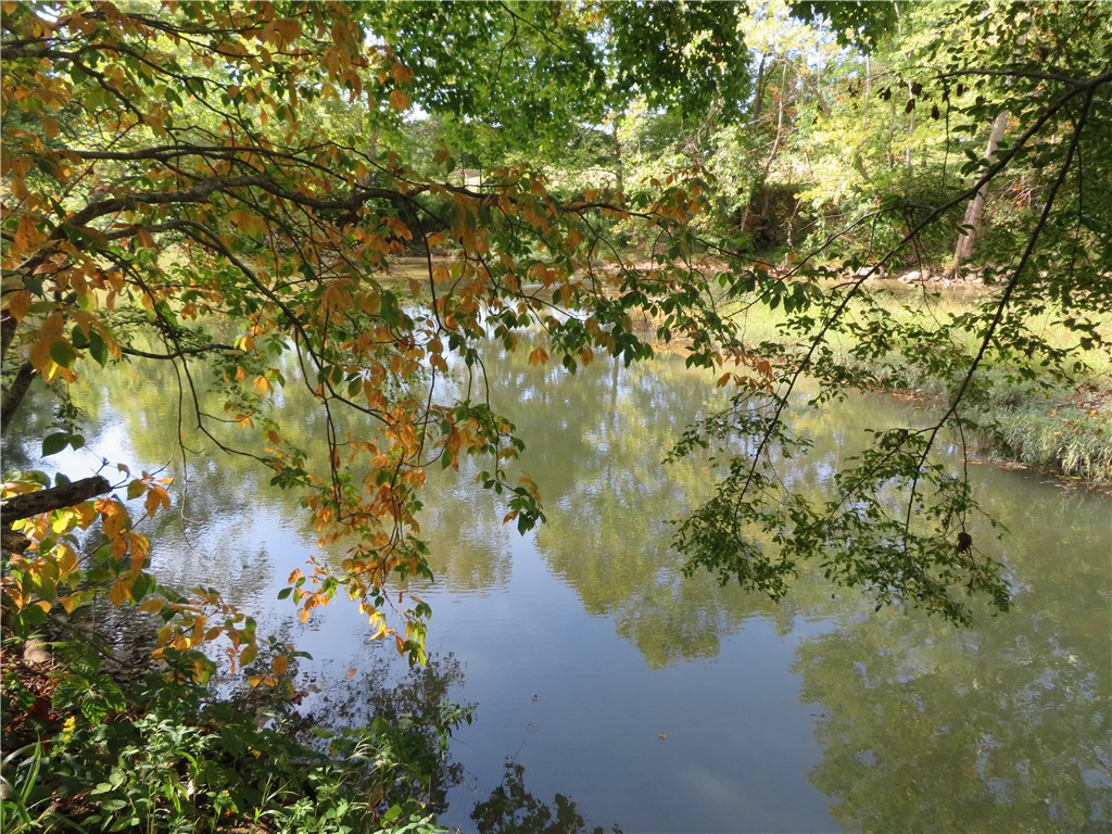 748 Inlow Avenue Peebles, OH 45660 - Photo 50 of 61 This tranquil waterfront setting offers a serene escape amidst lush greenery and reflective waters.