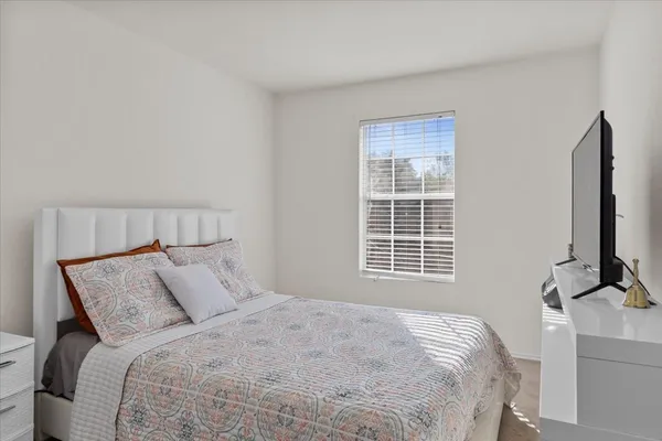a bathroom with a granite countertop sink and a toilet
