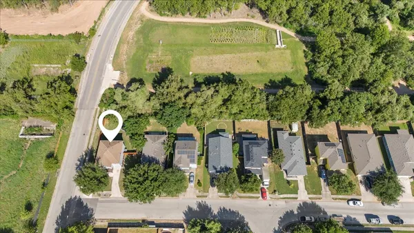 an aerial view of a residential apartment building with a yard and plants