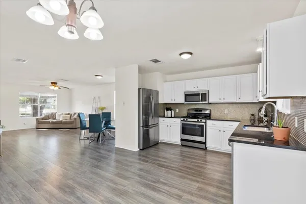 a living room with furniture wooden floor and a flat screen tv
