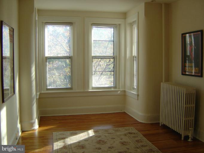 258 8th Street Southeast Washington, DC 20003 - Photo 2 of 30 a view of an empty room with wooden floor and a window