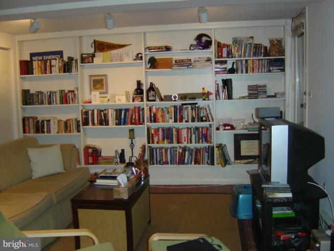 258 8th Street Southeast Washington, DC 20003 - Photo 8 of 30 a living room with furniture cabinets and a book shelf