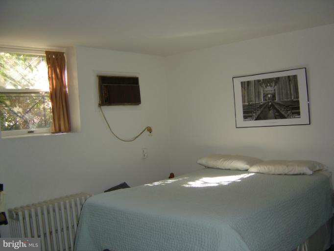 258 8th Street Southeast Washington, DC 20003 - Photo 9 of 30 a bedroom with a bed and a window