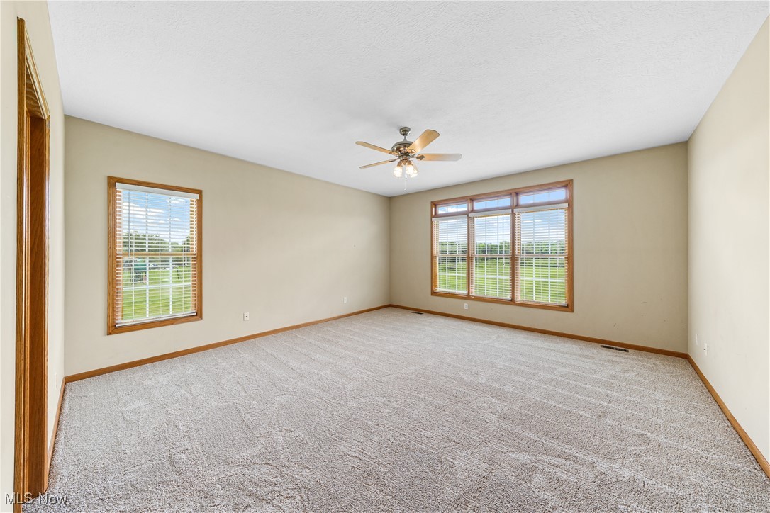 4840 Wayne Road Mantua, OH 44255 - Photo 20 of 42 Expansive Primary Suite with tons of natural light, beautiful view, brand new neutral carpeting