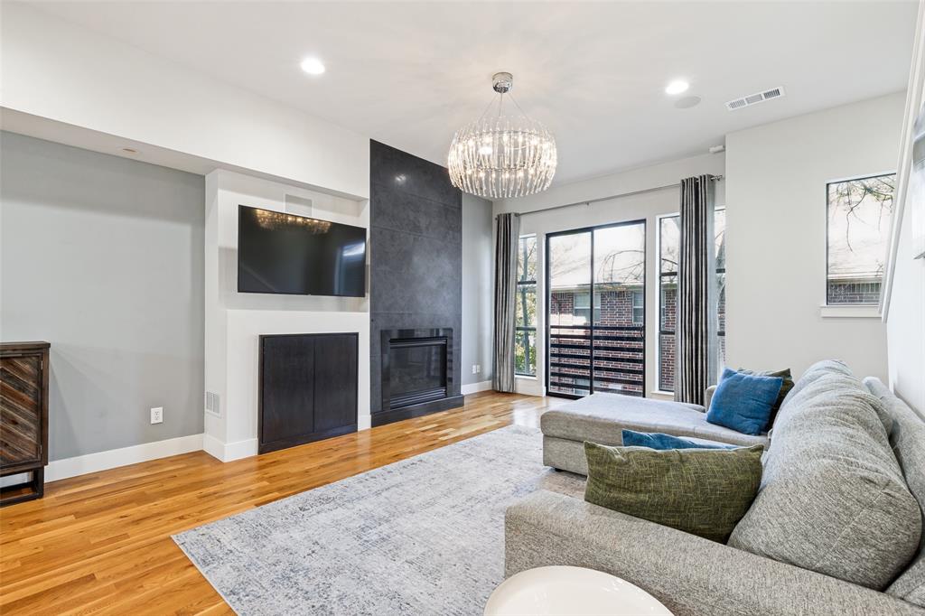 4618 Cedar Springs Road, Unit B Dallas, TX 75219 - Photo 11 of 24 a living room with furniture a fireplace and a flat screen tv