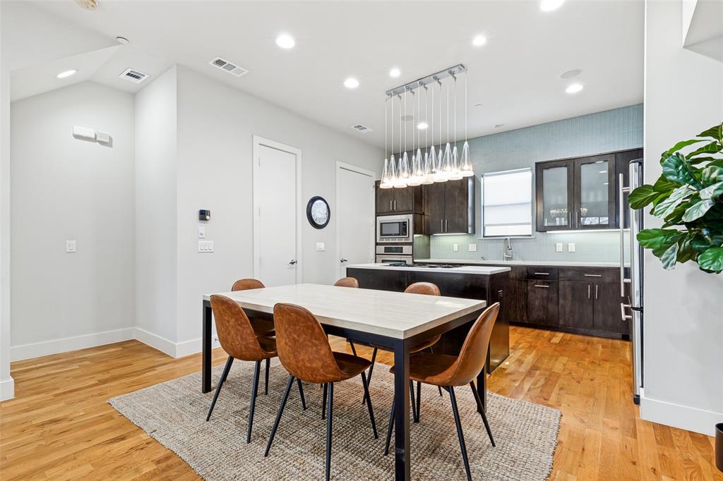 4618 Cedar Springs Road, Unit B Dallas, TX 75219 - Photo 16 of 24 a view of a dining room with furniture and wooden floor