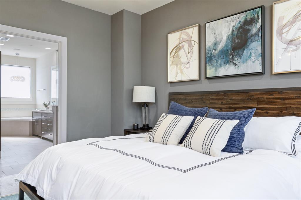 4618 Cedar Springs Road, Unit B Dallas, TX 75219 - Photo 18 of 24 a bedroom with a large bed and a painting on the wall