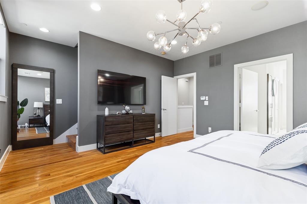 4618 Cedar Springs Road, Unit B Dallas, TX 75219 - Photo 19 of 24 a bedroom with a bed and a flat screen tv