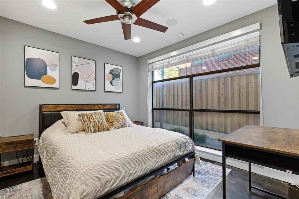 4618 Cedar Springs Road, Unit B Dallas, TX 75219 - Photo 4 of 24 a bedroom with a large bed and a chandelier