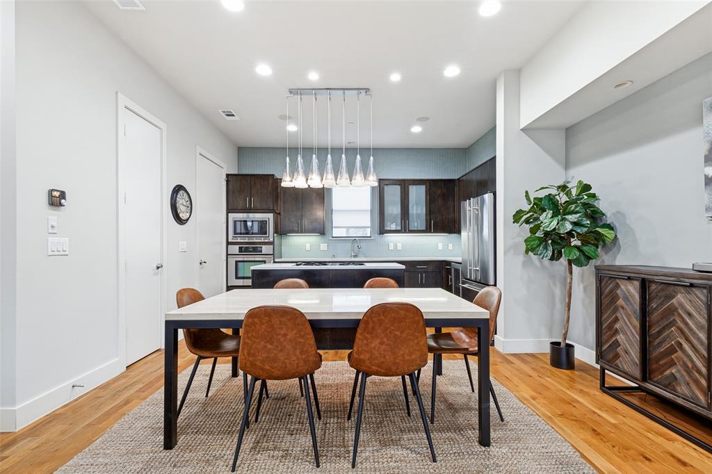 4618 Cedar Springs Road, Unit B Dallas, TX 75219 - Photo 7 of 24 a dinning room with furniture a potted plant and a fireplace