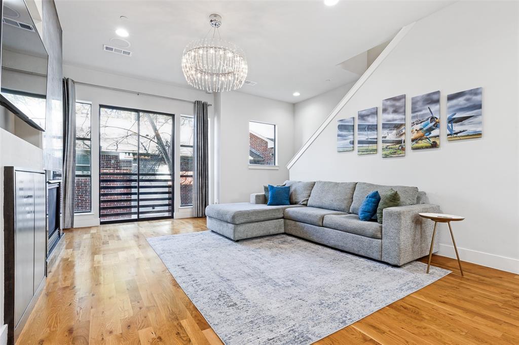 4618 Cedar Springs Road, Unit B Dallas, TX 75219 - Photo 8 of 24 a living room with furniture and a chandelier