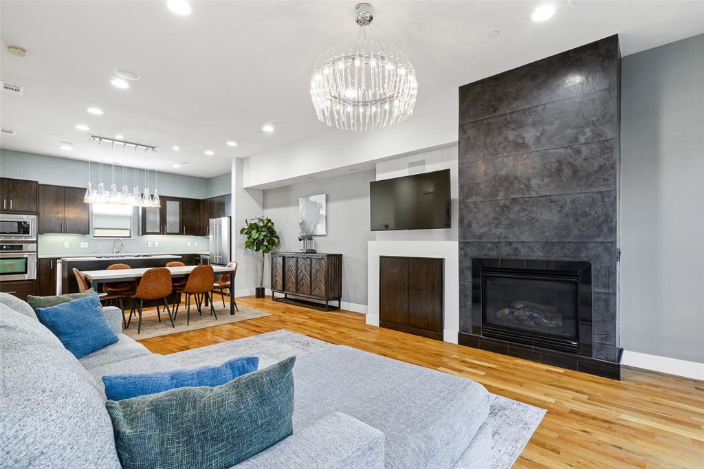 4618 Cedar Springs Road, Unit B Dallas, TX 75219 - Photo 10 of 24 a living room with furniture a fireplace and a flat screen tv