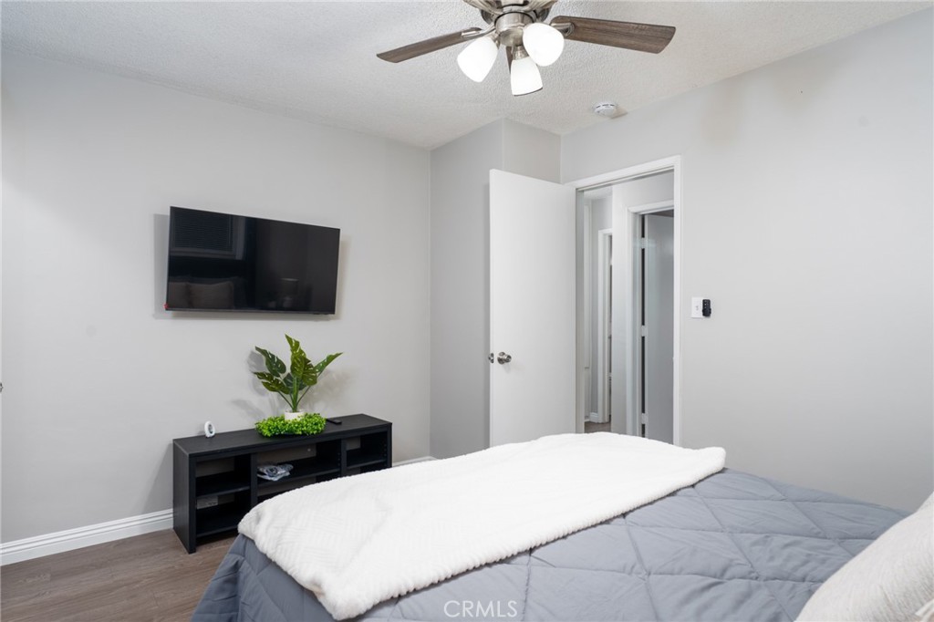 716 Orange Street Riverside, CA 92501 - Photo 14 of 28 a bedroom with a bed and a flat screen tv