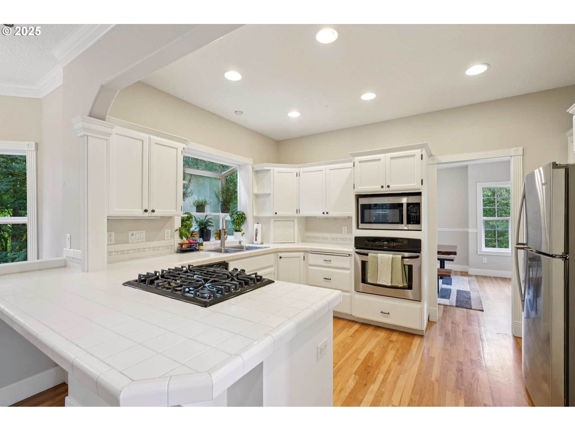 2144 Northwest 22nd Avenue Camas, WA 98607 - Photo 8 of 40 a kitchen with stainless steel appliances a stove a sink a refrigerator and cabinets
