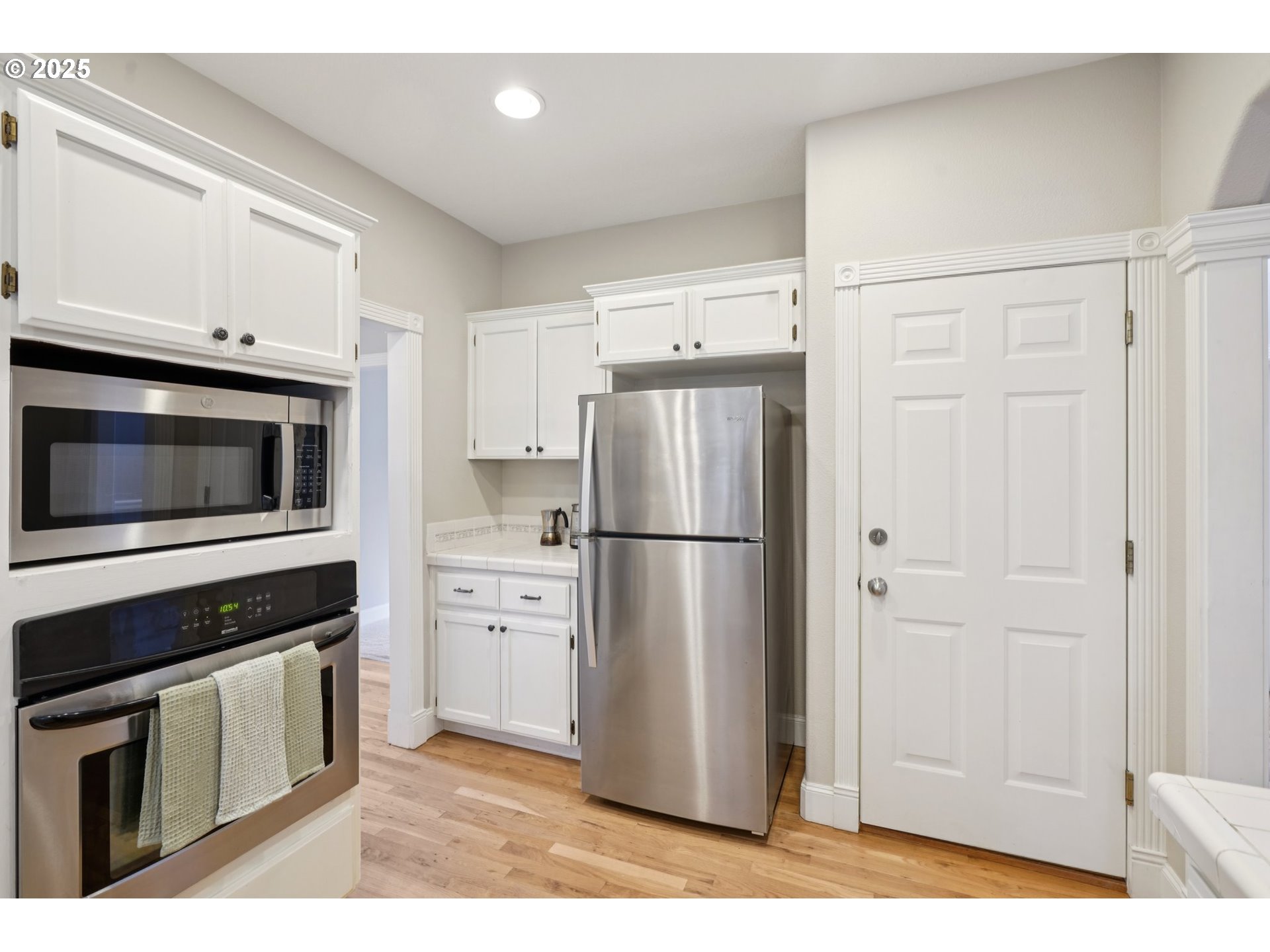2144 Northwest 22nd Avenue Camas, WA 98607 - Photo 9 of 40 a kitchen with a refrigerator stove and white cabinets